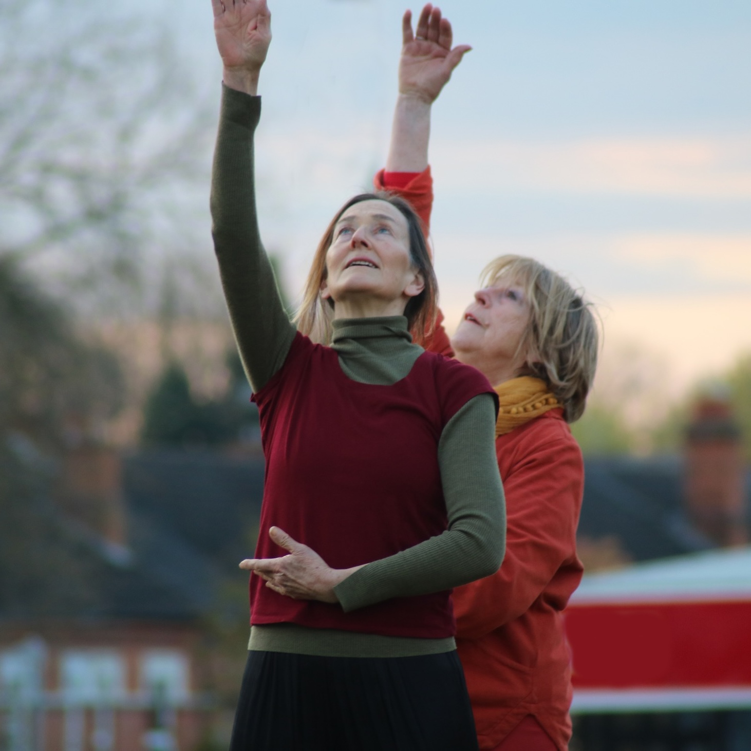 2 women dancing outdoors